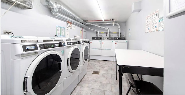 shared laundry area with washing machine and clothes dryer and visible vents