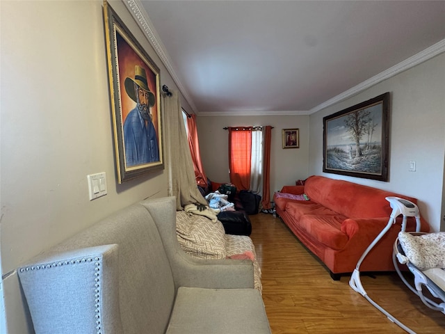 living area featuring crown molding and wood finished floors