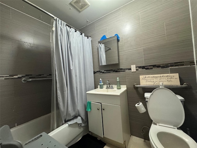 bathroom featuring vanity, toilet, shower / bath combo with shower curtain, and visible vents