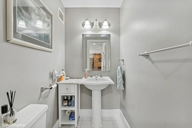 79 Sands Point Rd, Port Washington, NY 11050 - bathroom featuring visible vents, tile patterned flooring, toilet, baseboards, and a sink