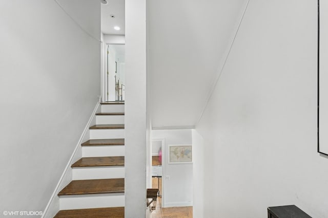 79 Sands Point Rd, Port Washington, NY 11050 - stairway with recessed lighting, baseboards, and wood finished floors