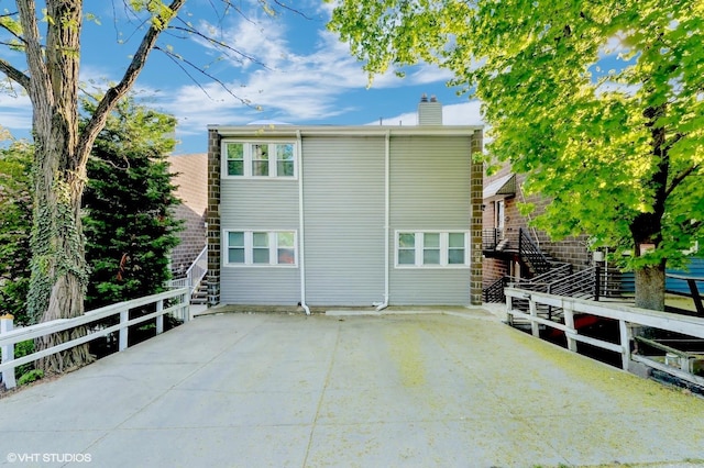 79 Sands Point Rd, Port Washington, NY 11050 - view of side of home with a chimney and a patio