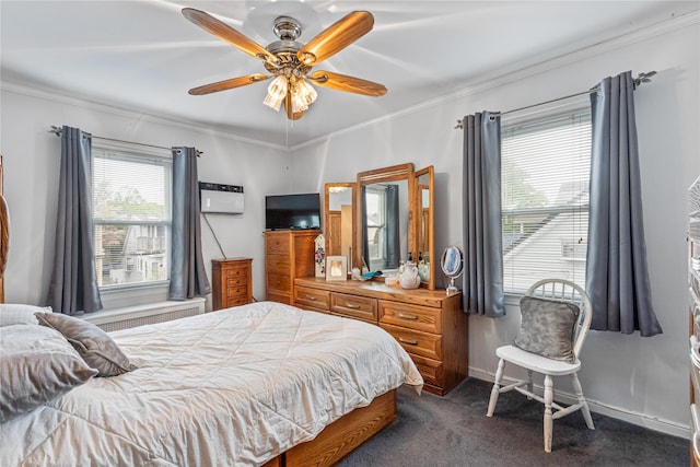 bedroom featuring ornamental molding, dark colored carpet, a wall mounted AC, a ceiling fan, and baseboards