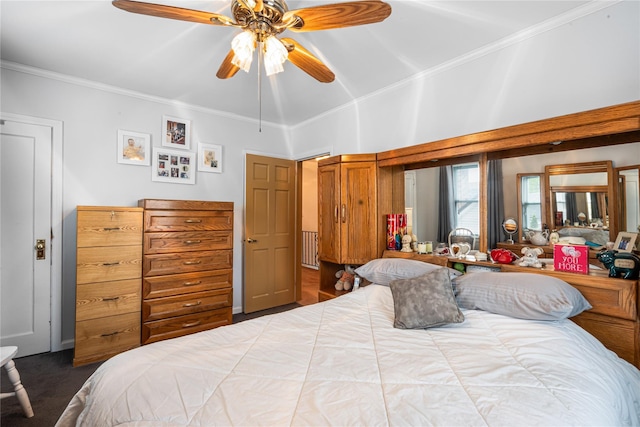 bedroom featuring a ceiling fan, ornamental molding, and carpet
