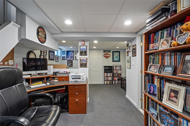 home office with a drop ceiling, dark colored carpet, and recessed lighting