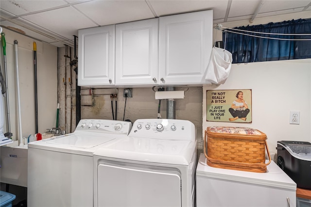 washroom featuring washer and clothes dryer and cabinet space