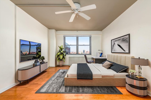 70-20 108th St Unit 15A, Forest Hills, NY 11375 - bedroom with baseboards, a ceiling fan, and wood finished floors