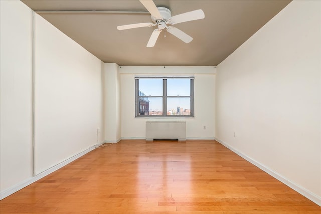 70-20 108th St Unit 15A, Forest Hills, NY 11375 - empty room with baseboards, radiator, ceiling fan, and light wood-type flooring