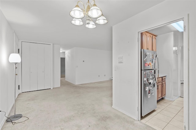 interior space featuring baseboards and a notable chandelier