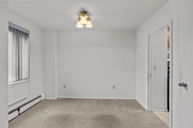 unfurnished room featuring a baseboard radiator, light carpet, and baseboards