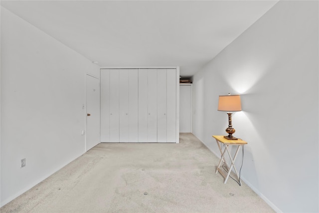 unfurnished bedroom with carpet floors and a closet