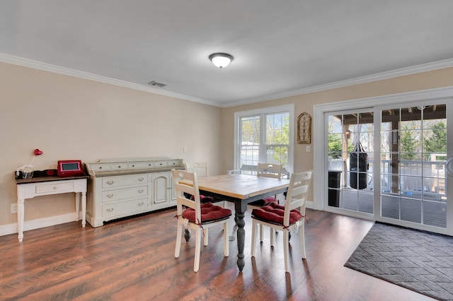 dining room with baseboards, ornamental molding, visible vents, and dark wood-style floors