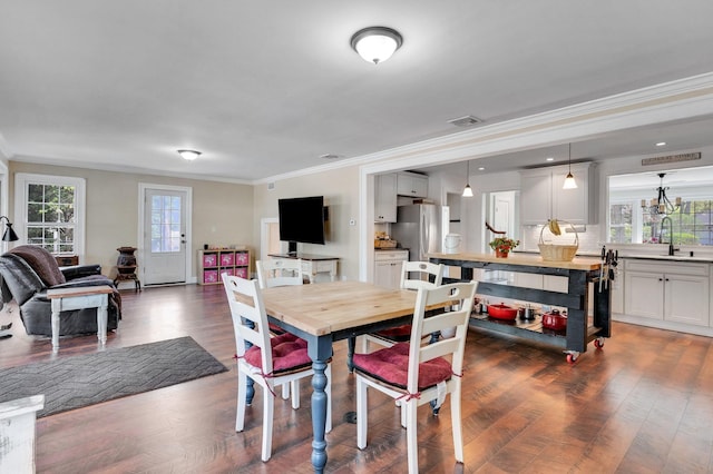 dining area featuring ornamental molding, dark wood finished floors, and visible vents