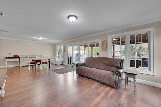 living room featuring ornamental molding and wood finished floors