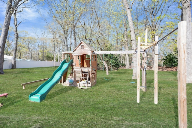 view of jungle gym with a lawn and fence
