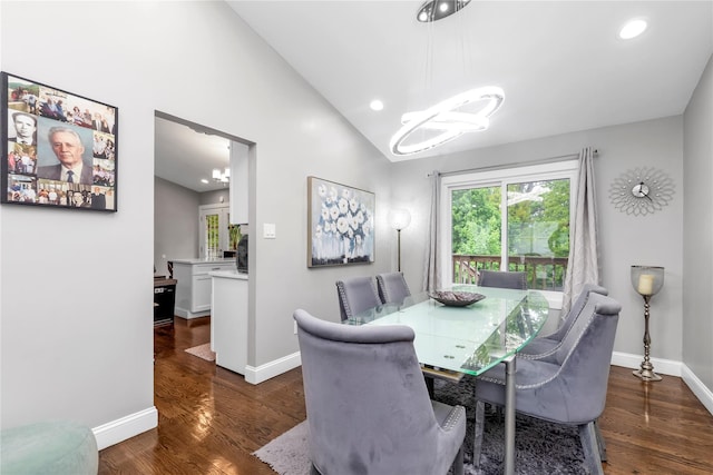 dining room with vaulted ceiling, baseboards, wood finished floors, a chandelier, and recessed lighting