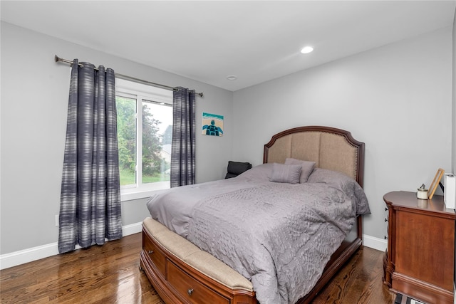 bedroom with dark wood finished floors, baseboards, and recessed lighting