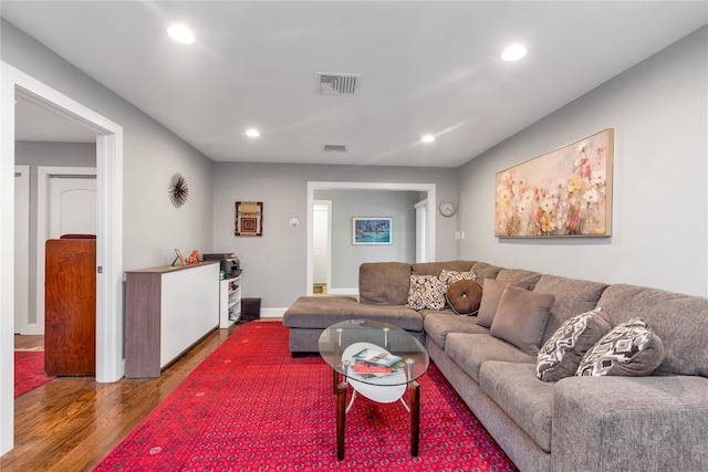 living area with wood finished floors, recessed lighting, and baseboards