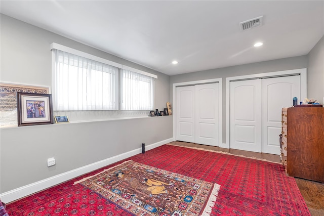 bedroom with multiple closets, baseboards, and recessed lighting
