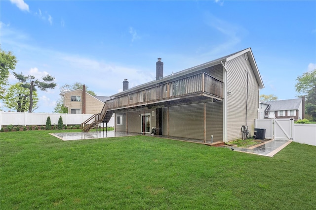 back of property with a patio, a gate, stairway, a deck, and central AC
