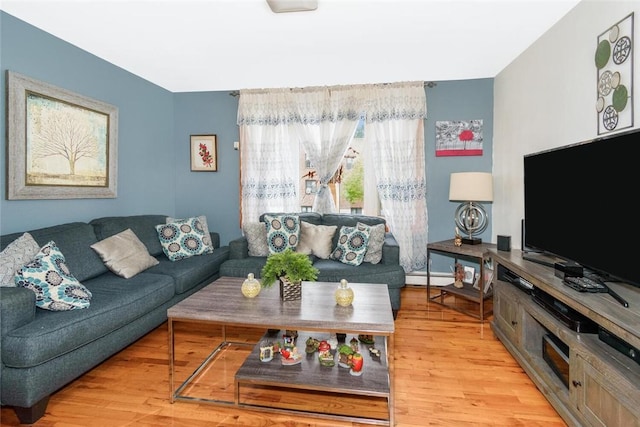 living room featuring wood finished floors and a baseboard heating unit