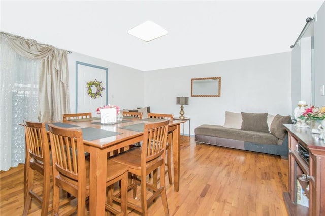 dining space featuring light wood-style flooring