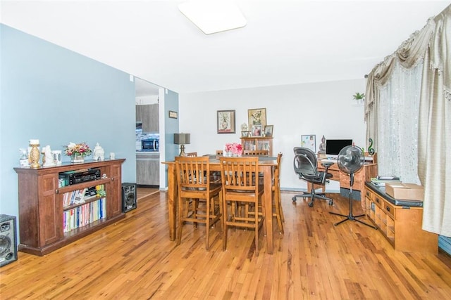 dining space featuring light wood-style floors