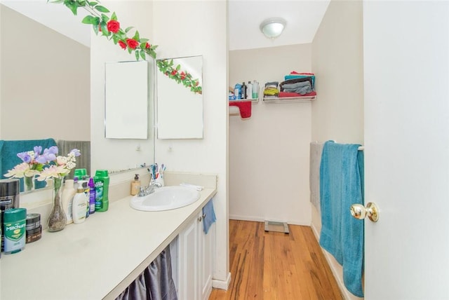 bathroom with vanity and wood finished floors
