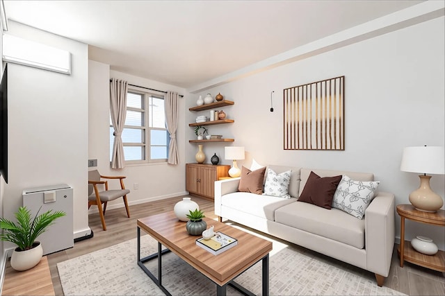 living area featuring light wood-style flooring and baseboards
