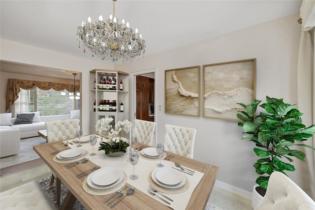 216 Maple Ave, Monroe, NY 10950 - dining area featuring light tile patterned floors, a chandelier, and baseboards