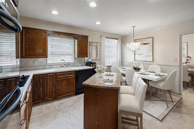 216 Maple Ave, Monroe, NY 10950 - kitchen with a sink, black dishwasher, ornamental molding, a center island, and a chandelier