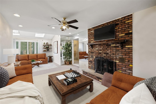 216 Maple Ave, Monroe, NY 10950 - carpeted living area featuring a ceiling fan, a fireplace, a skylight, and recessed lighting