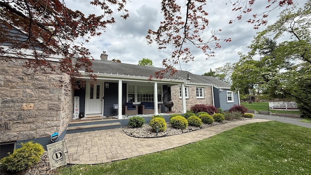 125 Kings Hwy, Congers, NY 10920 - view of front of home with stone siding, a porch, a front yard, and a chimney