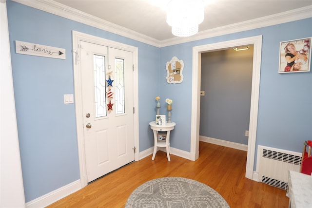 125 Kings Hwy, Congers, NY 10920 - foyer entrance with radiator heating unit, light wood-style flooring, baseboards, and crown molding