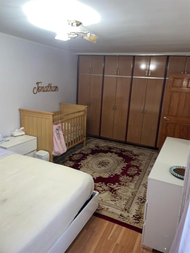 8340 Austin St Unit 5G, Kew Gardens, NY 11415 - bedroom featuring light wood-type flooring and ornamental molding