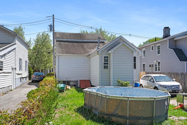 rear view of house with fence
