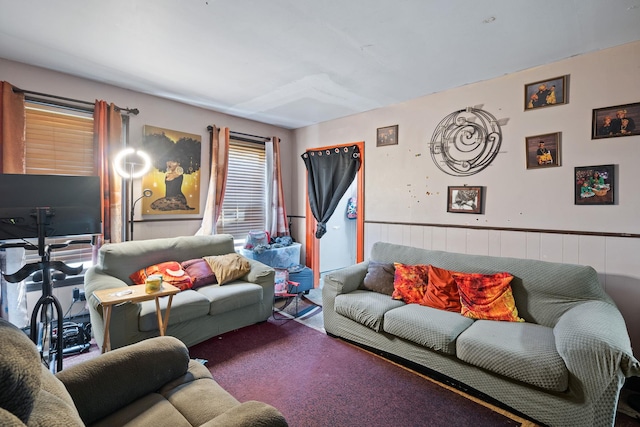 carpeted living room featuring wainscoting