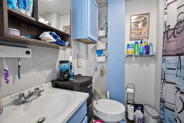 full bath featuring vanity and toilet