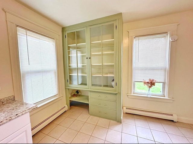 interior space featuring light tile patterned floors and baseboard heating