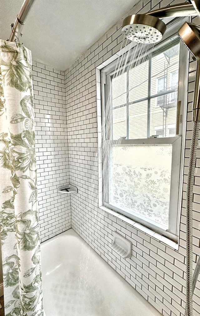 bathroom featuring shower / tub combo with curtain