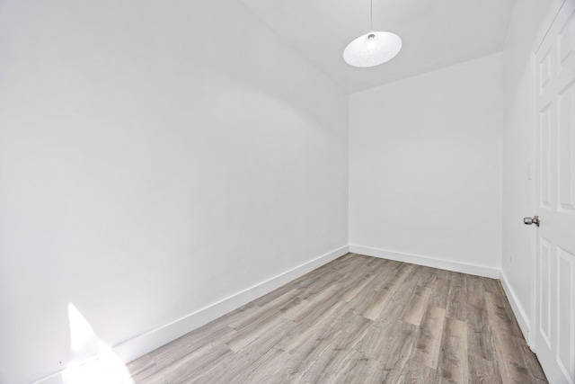 unfurnished room featuring light wood-style floors and baseboards