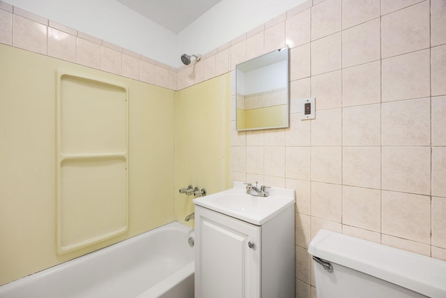 bathroom with shower / bath combination, vanity, tile walls, and toilet