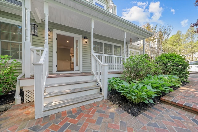 entrance to property featuring a porch