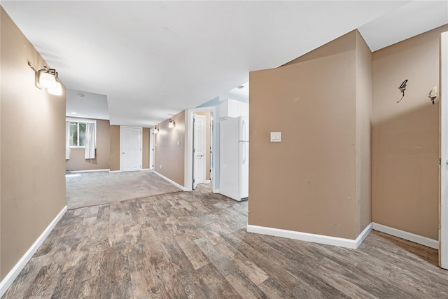 hallway with baseboards and wood finished floors