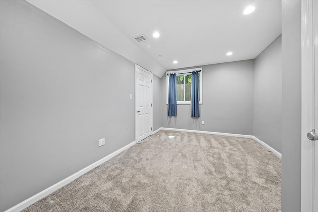 carpeted empty room featuring baseboards and recessed lighting