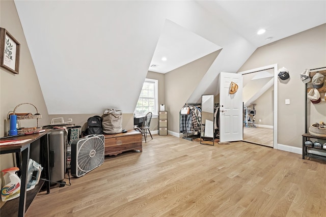 additional living space with wood finished floors, lofted ceiling, baseboards, and recessed lighting
