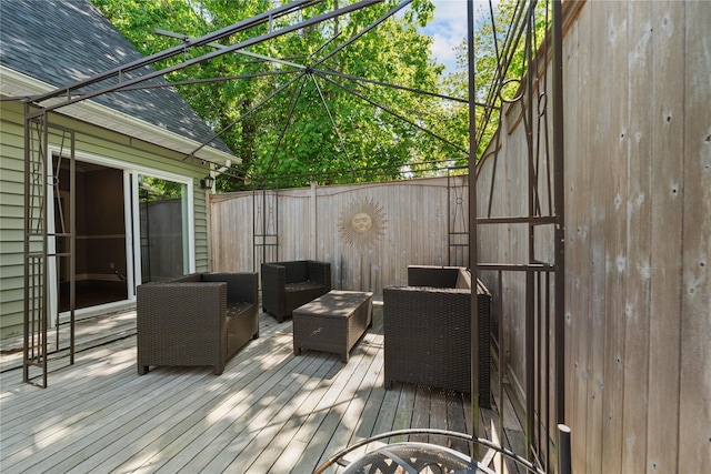 wooden deck with an outdoor living space and fence