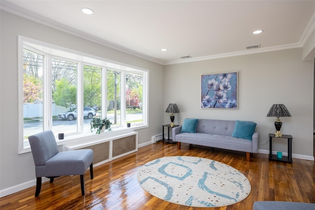 living area with crown molding, baseboards, wood finished floors, recessed lighting, and baseboard heating