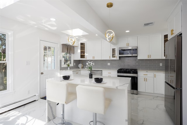 kitchen featuring stainless steel appliances, light marble finish floors, a baseboard radiator, backsplash, and recessed lighting