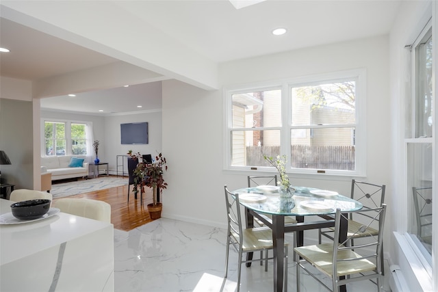 dining area featuring recessed lighting, light marble finish flooring, and baseboards